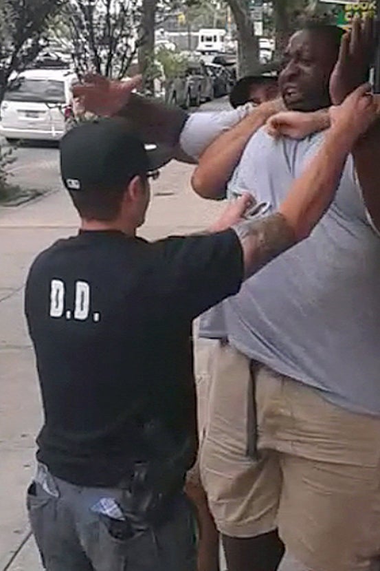 An image from the video showing NYPD officers tackling Garner before his death.