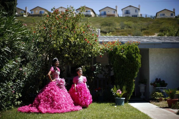 Mimi Pineda (at left), whose parents are from El Salvador, stands outside her aunt's house before her quinceaƱera, or 15th birth day, in Santa Clarita, California.