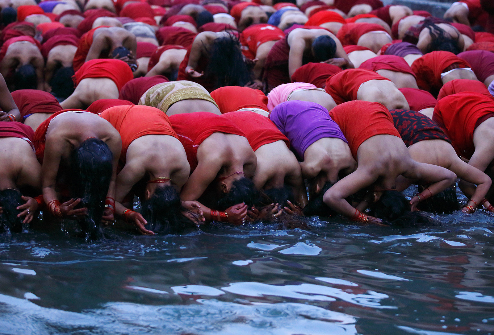 Devotees take a holy bath during the Swasthani Brata Katha festival in Kath...