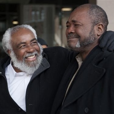 Wiley Bridgeman, 60, of Cleveland, left, is all smiles as his brother Ronnie, who is now known as Kwame Ajamu chokes up as they walk from the Cuyahoga County Justice Center after Bridgeman's release from a life sentence for a 1975 murder on Nov. 21, 2014 in Cleveland.