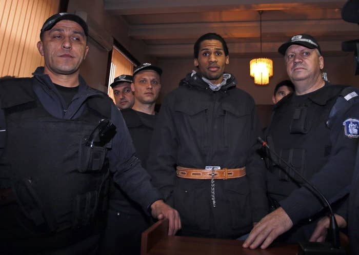 French citizen Fritz-Joly Joachin (C) arrives under police escort at a court in the southern city of Haskovo January 20, 2015. Joachin, arrested in Bulgaria for alleged links to the gunmen who attacked the satirical newspaper Charlie Hebdo, denies being part of an Islamist group and is ready to be extradited to prove his innocence, his lawyer said last Friday.