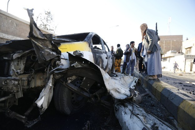 Policemen gather at the scene of a car bomb attack outside a police college in Sanaa Jan. 7.