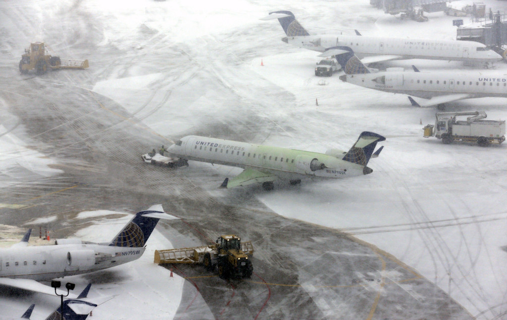 Airplanes stand in the snow at O'Hare International Airport on Sunday.