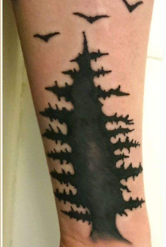 Black tree tattoo on the left forearm - Tattoogrid.net