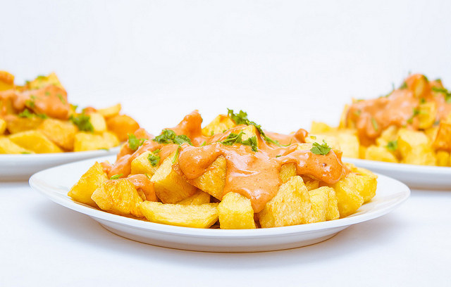 A traditional Spanish dish consisting of fried potatoes in a spicy tomato aioli sauce.