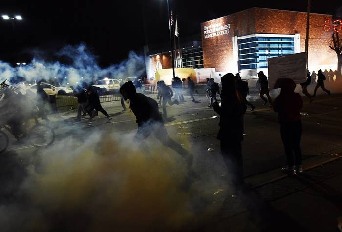Demonstrators flee as police fire tear gas during clashes following the grand jury decision in the death of 18-year-old Michael Brown in Ferguson, Missouri, on Nov. 24, 2014.