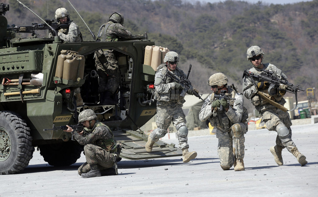 U.S. Army soldiers from the 25th Infantry Division's 2nd Stryker Brigade Combat Team and South Korean soldiers take their position during a demonstration.