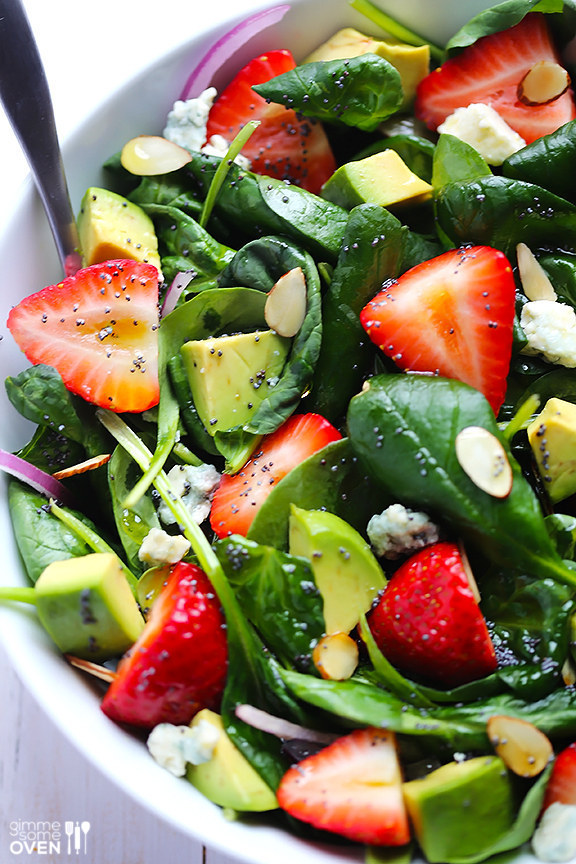 Strawberries, avocados, and spinach dressed with poppy seeds and honey.