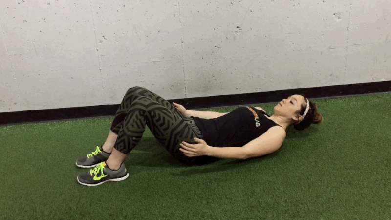 Squeeze your abs and use your core muscles to pull you up from the floor into a seated position.