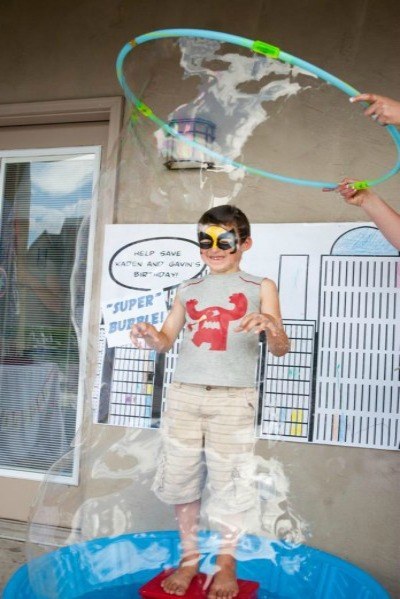 Make a super-bubble station using a hula hoop and dish soap from the dollar store.