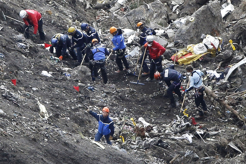 In this March 26 file photo, rescue workers sift through debris of the Germanwings jet at the crash site near Seyne-les-Alpes, France.