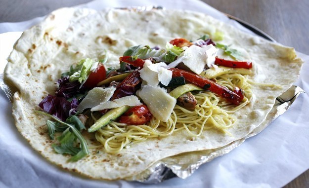 Piadas are custom-rolled wraps in a stone-grilled, thin-crusted dough made from organic flour and extra virgin olive oil with numerous pastas, meats, cheeses, sauce and vegetables as toppings.