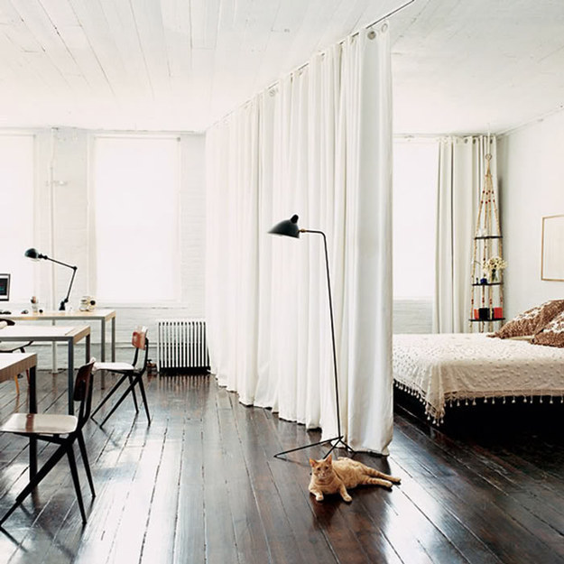 If you want to make a small space feel bigger, put up a white curtain instead of a new wall.