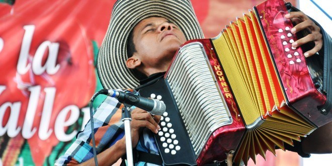 Vallenato is folk music from the Caribbean coast of Colombia, the key instrument is the accordion and tons of passion. We also have 'cumbia' as part of folk music but we are more likely to dance vallenato at a party.Here is a song by the Colombian singer Carlos Vives: 'Carito me habla en inglés' It's the story of a boy who falls in love with his Bostonian English teacher, Caroline.