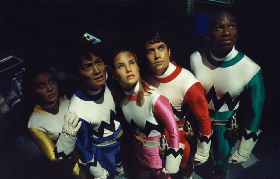 five power rangers look up at the ceiling