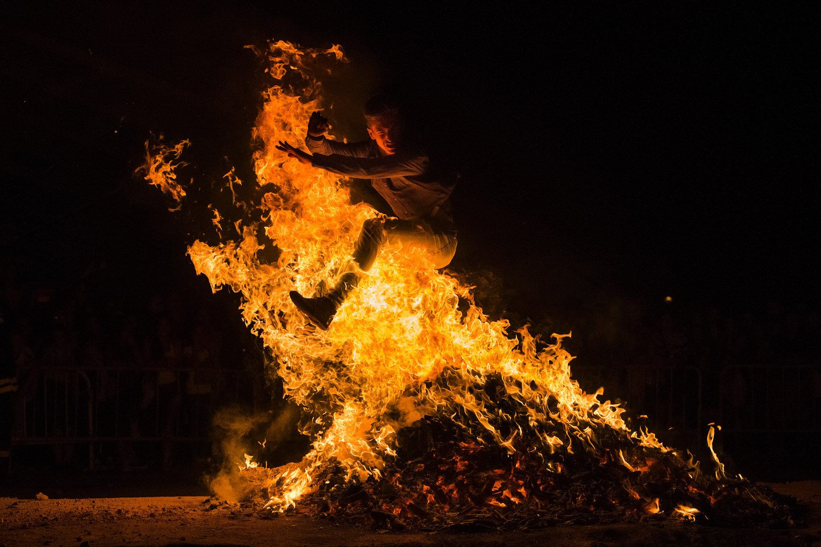 A reveler jumps over a bonfire during the night of San Juan in Alcobendas near Madrid, Spain. The San Juan night coincides with the Summer solstice and it's the welcome to Summer. This celebration takes place during the shortest night of the year in almost all cities and towns of Spain.
