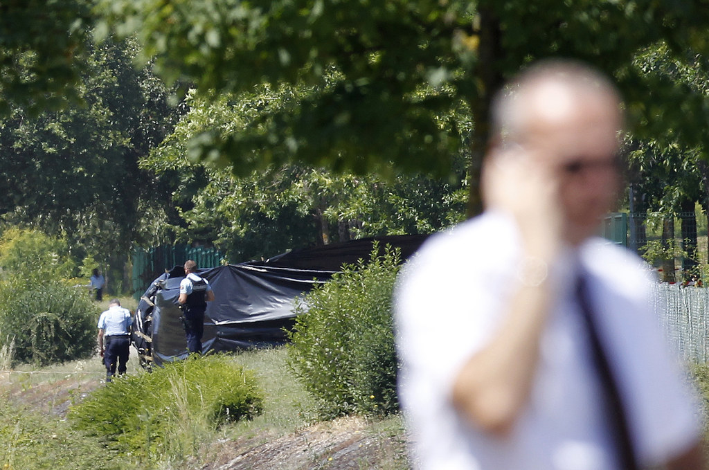 French Gendarmes stand guard next to a black plastic sheet outside the Air Products factory in Saint-Quentin-Fallavier, June 26.