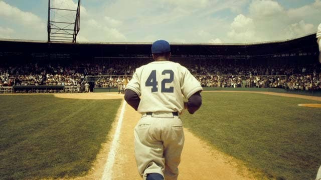 42 tells the story of Jackie Robinson's first year in the Majors as he has to deal with racism in America as he breaks the color barrier. This movie does a great job of showcasing the struggles and challenges Robinson had to deal with as he traveled through segregated America.