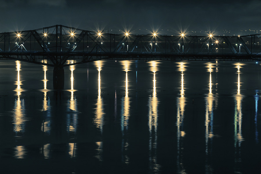 The Alexandra Bridge, gateway between Ottawa and Gatineau, reflects on repeat upon the Ottawa River.