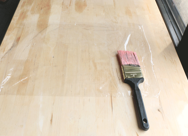 No need to clean up if you're going to use the same brush the next day. Wrap the brush in plastic and store in the fridge. You should be good to go when you start back up.