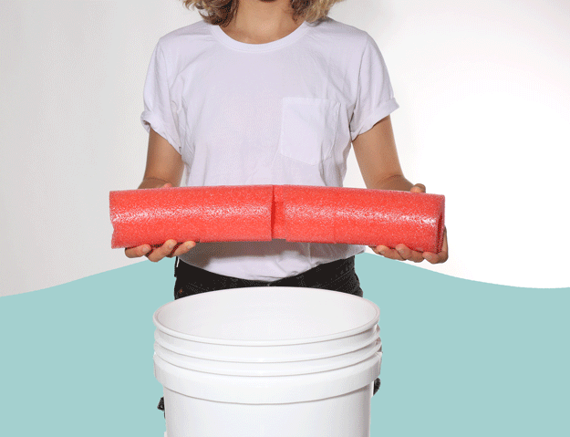 Not waiting to place the paintbrush just anywhere? You can use a pool noodle to hold it in place. Cut slits along the pool noodle with a utility knife and wrap it around the brim of the bucket.