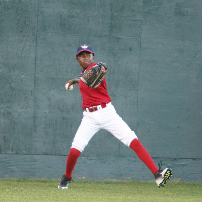 Raymond &quot;Ray&quot; Brown makes a throw from the outfield to home plate.