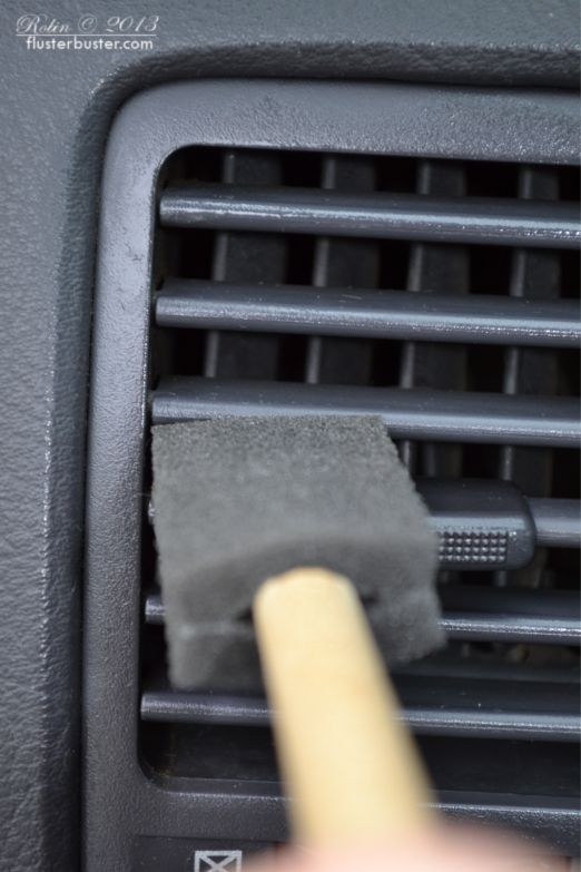 Use a cheap foam brush or paint brush to dust between the AC vents.