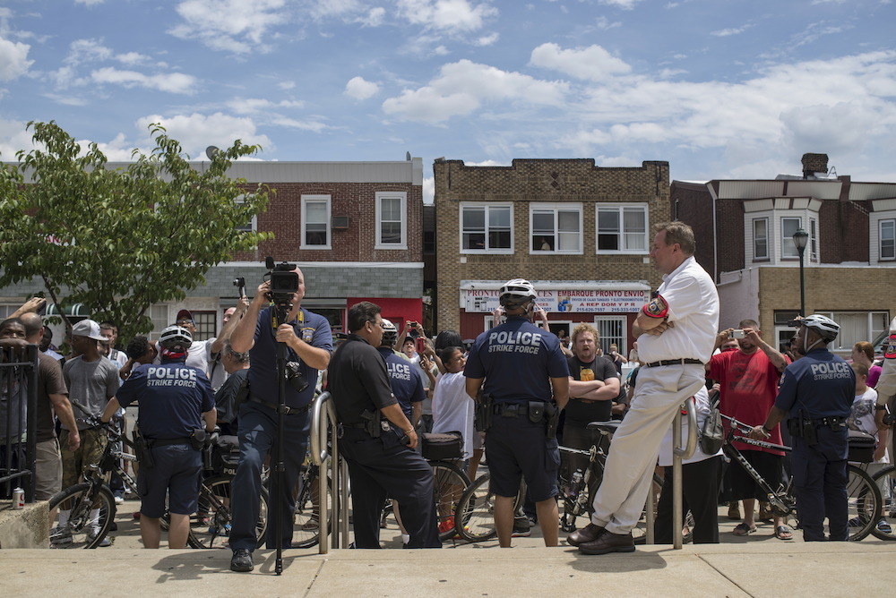 Police block a crowd that gathered to protest a rally by the East Coast Knights, which claims affiliation with the Ku Klux Klan, outside a library in Philadelphia, Pennsylvania, June 21, 2014.