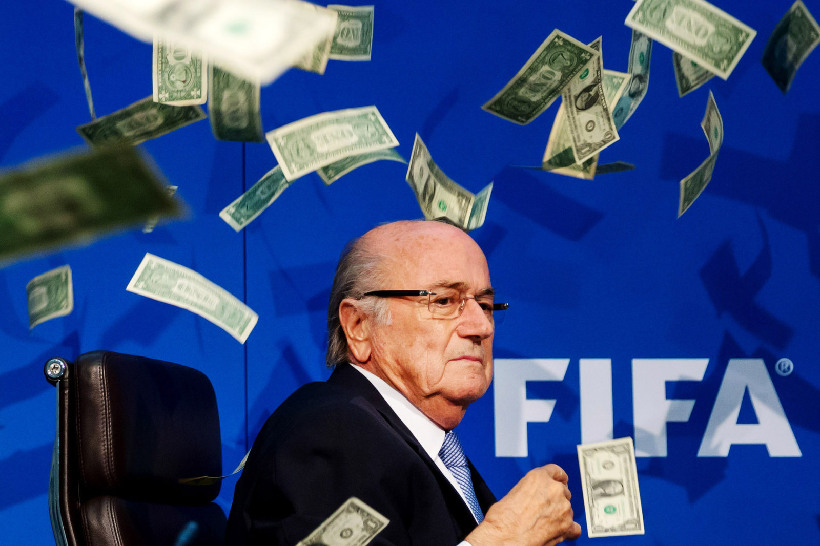 Comedian Simon Brodkin throws dollar bills at FIFA President Joseph S. Blatter during a press conference at the Extraordinary FIFA Executive Committee Meeting in Zurich, Switzerland.