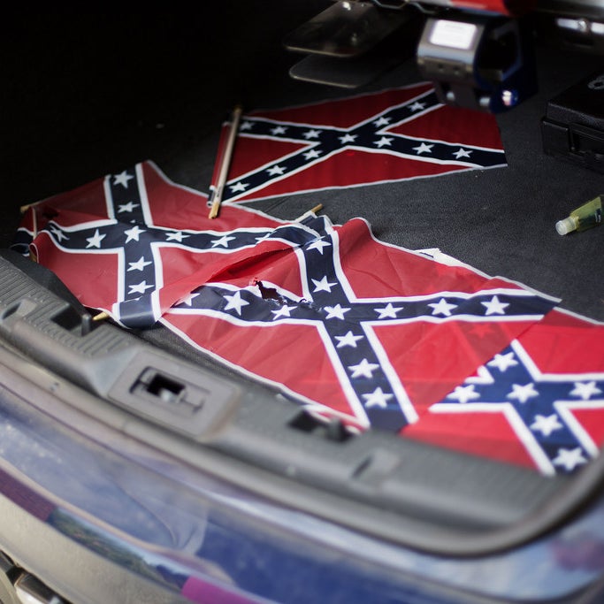 Confederate flags sit in the back of a police car outside Ebenezer Baptist Church.