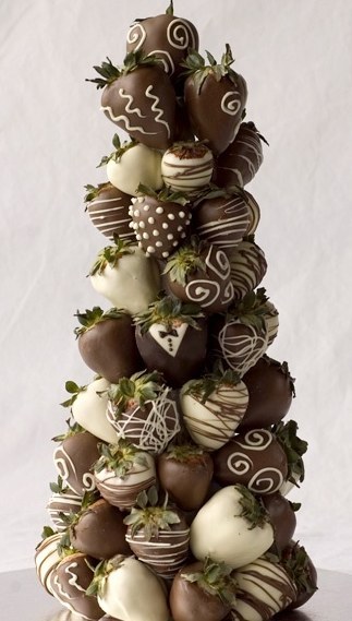 Chocolate covered strawberries are one of the most romantic foods in the world, so it makes sense to include them in your wedding. A small set of them included on each table, stacked elegantly, is a delectable option for a centerpiece, and is sure to set the theme for an elegant wedding.