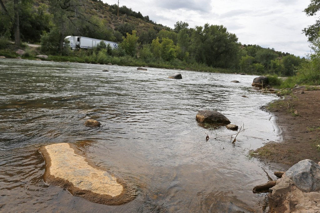 Dried yellow residue remains on a rock in Animas River on Aug. 11.