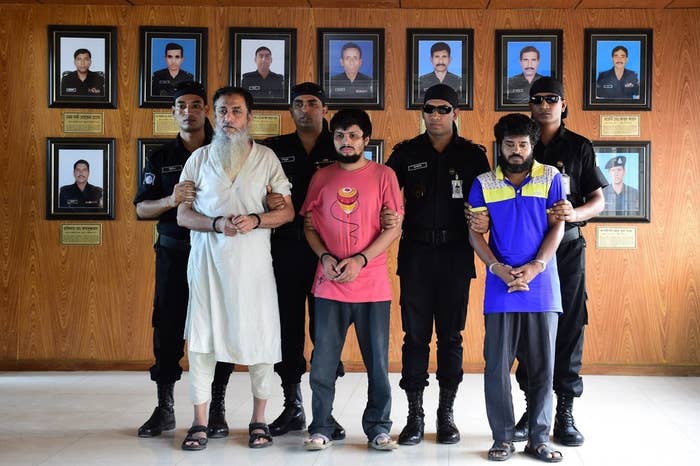 Bangladeshi Rapid Action Battalion personnel accompany Touhidur Rahman, (second left), Sadek Ali (center) and Aminul Mallick (second right), Aug. 18.