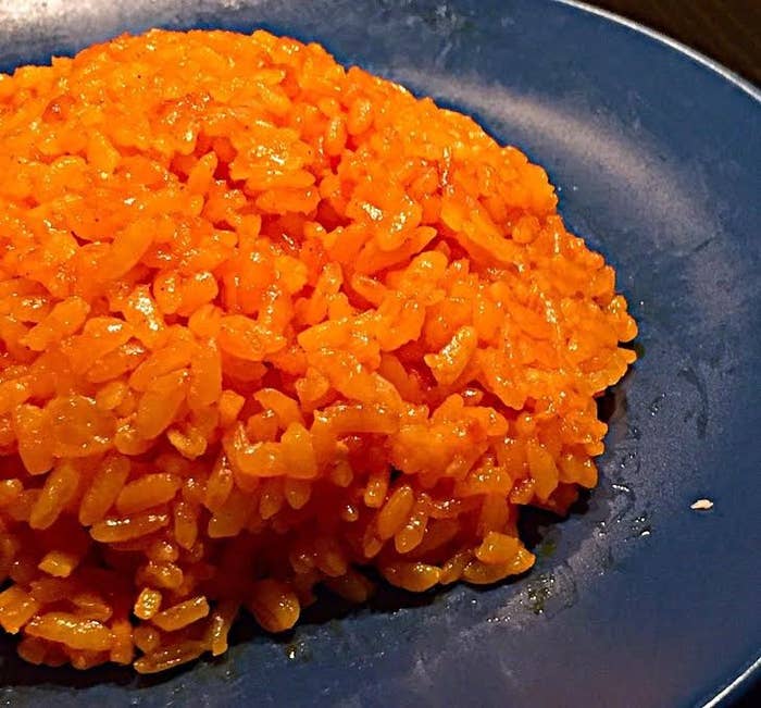 Kicking the flavor of rice up a notch with achote(annatto) seeds for some color and flavor, onions, spices, and some bacon bits! Mmmmm!