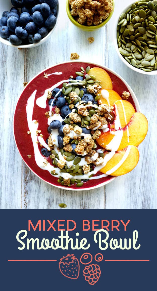 To make the smoothie, blend mixed berries, pomegranate juice, and yogurt. The toppings are blueberries, peach, mulberries, pumpkin seeds, and a drizzle of yogurt.To get a better drizzle with your yogurt, add a little water or milk to loosen it up. You can find mulberries (the little brown dried fruits in the photo) in the dried fruit section of your supermarket. Get the recipe at the bottom of the post.