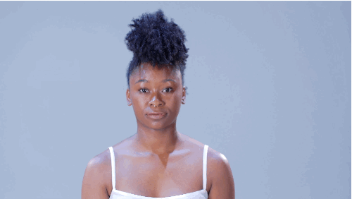 • Section the hair into three parts: front, middle, and back. • Smooth the front section up. Secure near the center of the head with a hair tie. Repeat with the remaining sections.• Tousle curls to create the Mohawk-inspired shape. Finish with hairspray.