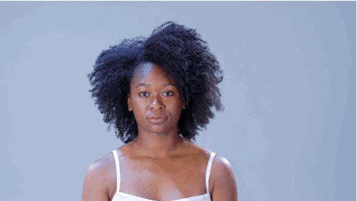 • Section hair down the scalp to create a part. Apply styling cream to your hands and glide it along curls to define the wedge shape. Your goal is to elongate the curls on both sides of the part. • Apply a bit of cream to your hands, then shake your hands through your hair to create more volume.
