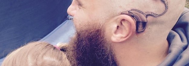 Father comforts daughter with cochlear implant with matching tattoo   king5com