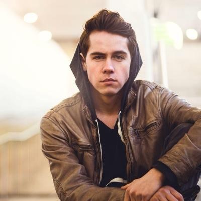 Just casually brooding in a leather jacket/hoodie combo, impregnating you with his eyes.