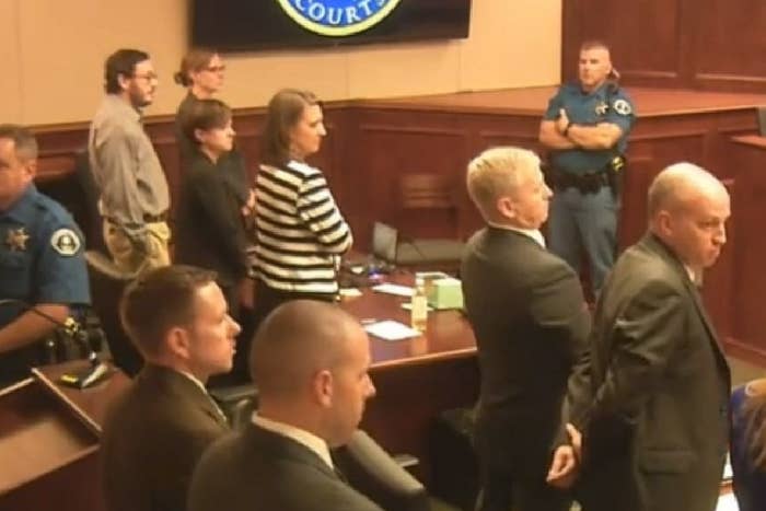 James Holmes, top left in tan shirt, listens to the verdict forms being read.