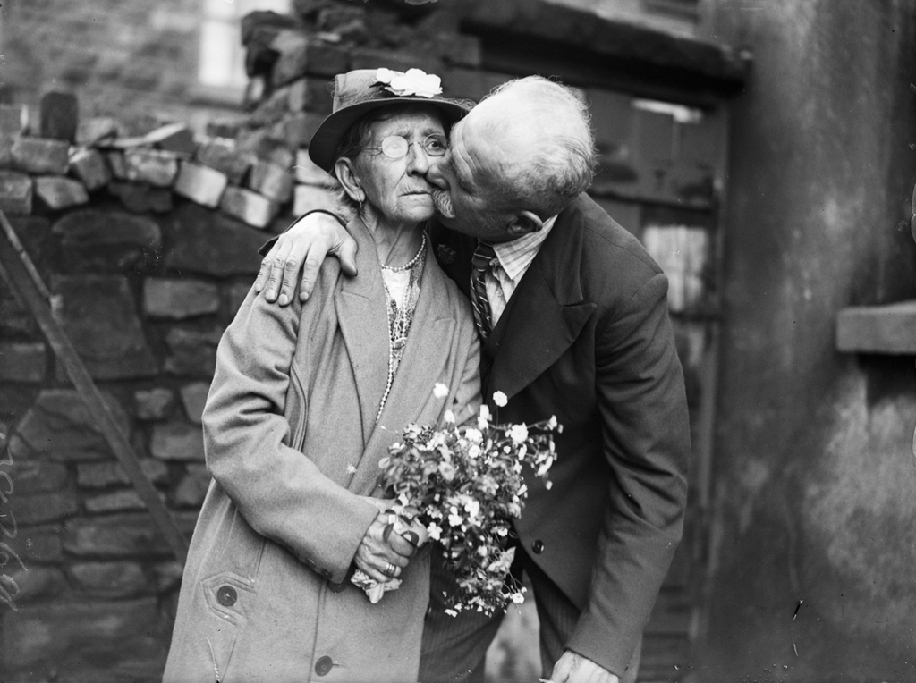 76-year-old Evan Ellis of Anglesey kissing his bride, 70-year-old Mary Ann Kinsley after their wedding at Ton Pentre, Rhondda. July 1936.