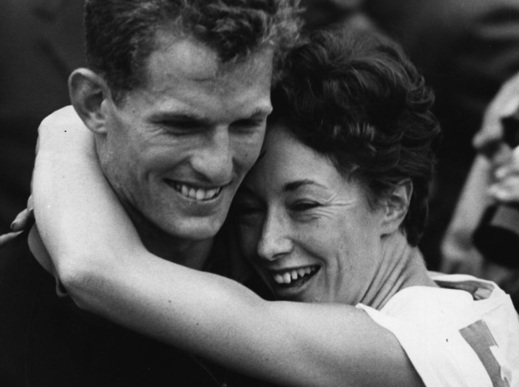 Ann Packer de Grande-Bretagne, championne de la finale du 800 m aux jeux olympiques de Tokyo 1964, embrassant Robbie Brightwell, son partenaire et le capitaine de l&#x27;équipe britannique. Elle remporta également l&#x27;argent au 400 m.