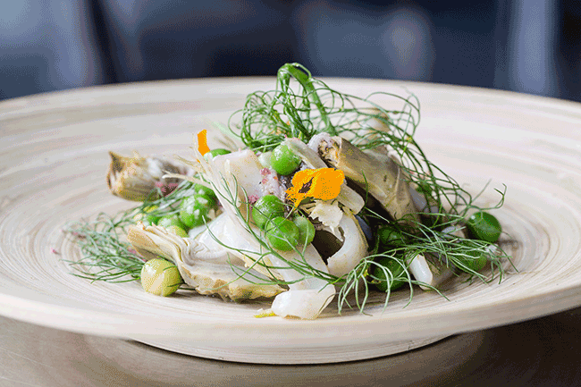 This beautiful work of culinary art from Sirena has shaved fennel, baby artichokes, English peas, crispy bacon, mint vinaigrette shaved celery, lemon sorbet, and fresh squid. And yes, it tastes as good as it looks!