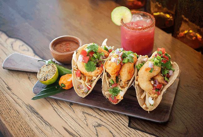 Hooray for shrimp! This tasty trio from chefs John Gray & Deborah Scott of Coasterra consists of Mexican white shrimp, morita aioli, cabbage, pico de gallo, Mexican rice, and pinto beans served up in fresh corn tortillas.