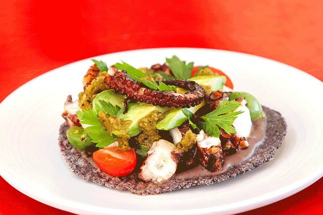 This tasty tostada from Galaxy Taco has a bean puree, avocado, tomato, and burnt orange-habanero salsa. Octopus lovers unite!