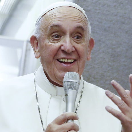 Pope Francis talks aboard the papal plane while en route to Italy September 28, 2015.