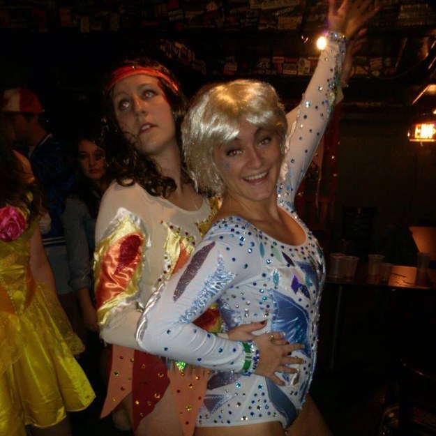 Two people in colorful beaded leotards and wigs