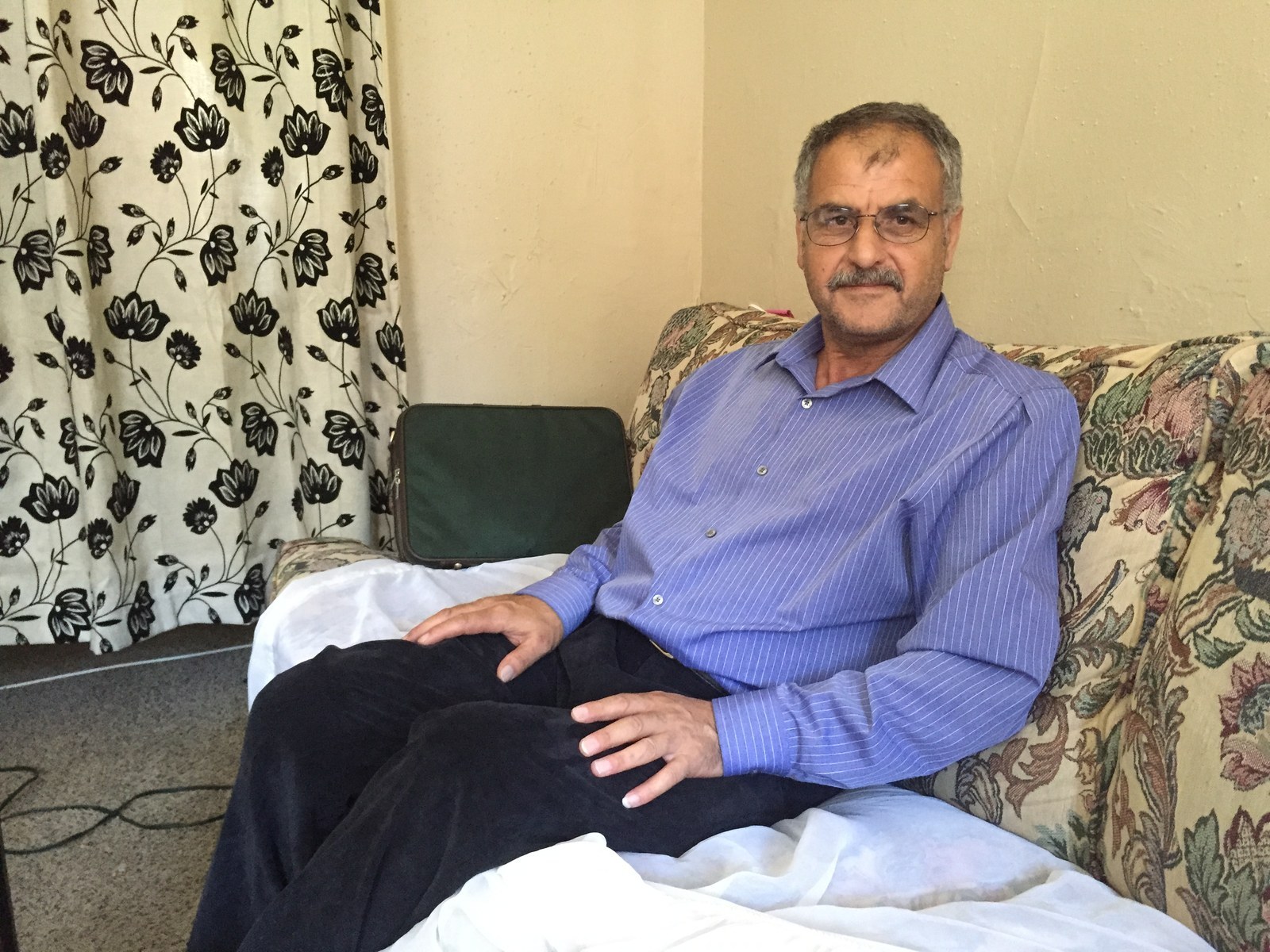 Farhan sits in his living room in Lancaster, Pennsylvania.