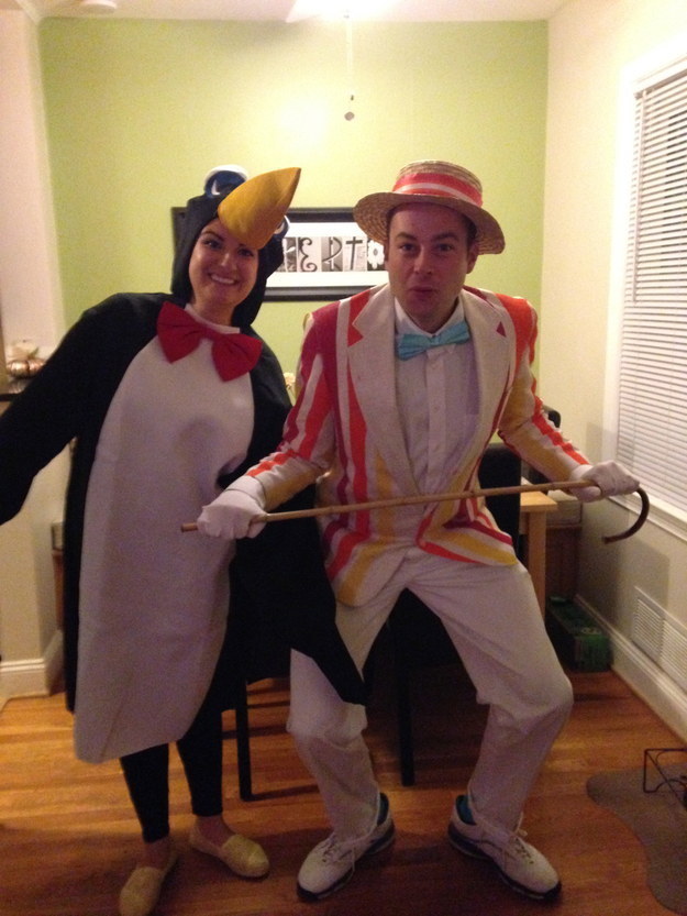 One person dressed in a penguin costume and one person wearing a striped suit