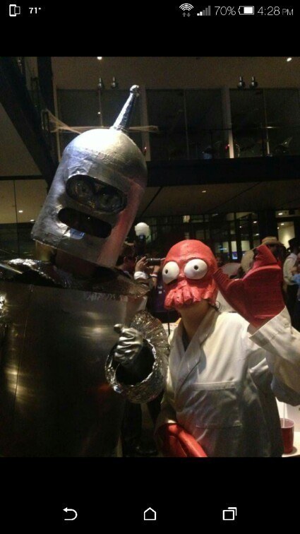 One person dressed as a robot and one person dressed as a lobster